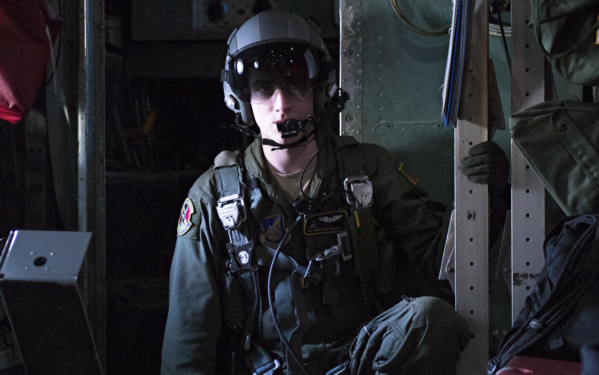 Airman 1st Class Christian Williams, 36th Airlift Squadron C-130 loadmaster, communicates with the pilots in preparation of opening the cargo door of a C-130 Hercules, above Camp Fuji drop zone, Japan. This drop marks the last flight of 2016 for Yokota Air Base’s C-130 Hercules. (U.S. Air Force photo by Airman 1st Class Juan Torres)