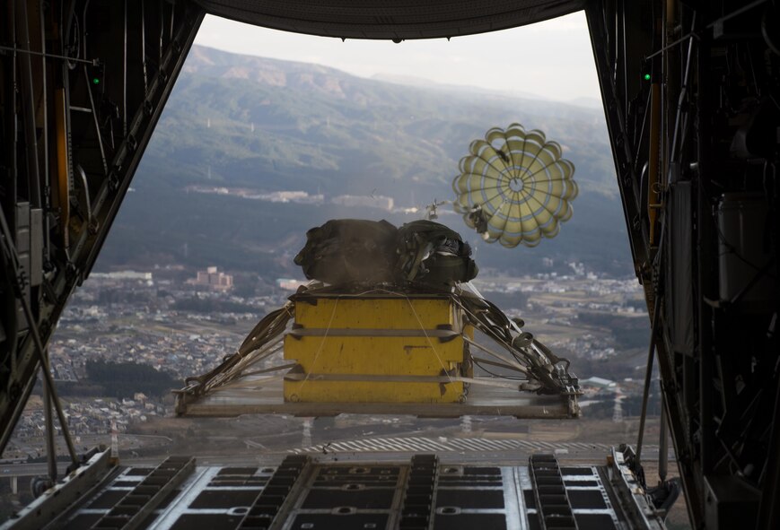 A heavy cargo is dropped mid-flight Dec. 15, 2016, over the Camp Fuji drop zone, Japan. This drop marks the last flight of 2016 for Yokota Air Base’s C-130 Hercules. (U.S. Air Force photo by Airman 1st Class Juan Torres)