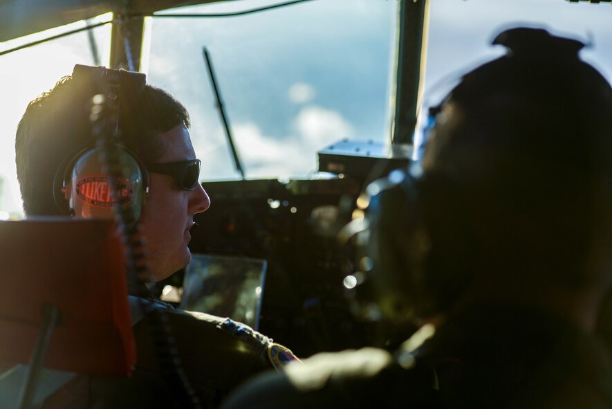A pilot assigned to the 36th Airlift Squadron, communicates with his co-pilot after a successful airdrop Dec. 15, 2016, near Camp Fuji drop zone, Japan. This drop marks the last flight of 2016 for Yokota Air Base’s C-130 Hercules. (U.S. Air Force photo by Senior Airman Justin Carnahan)