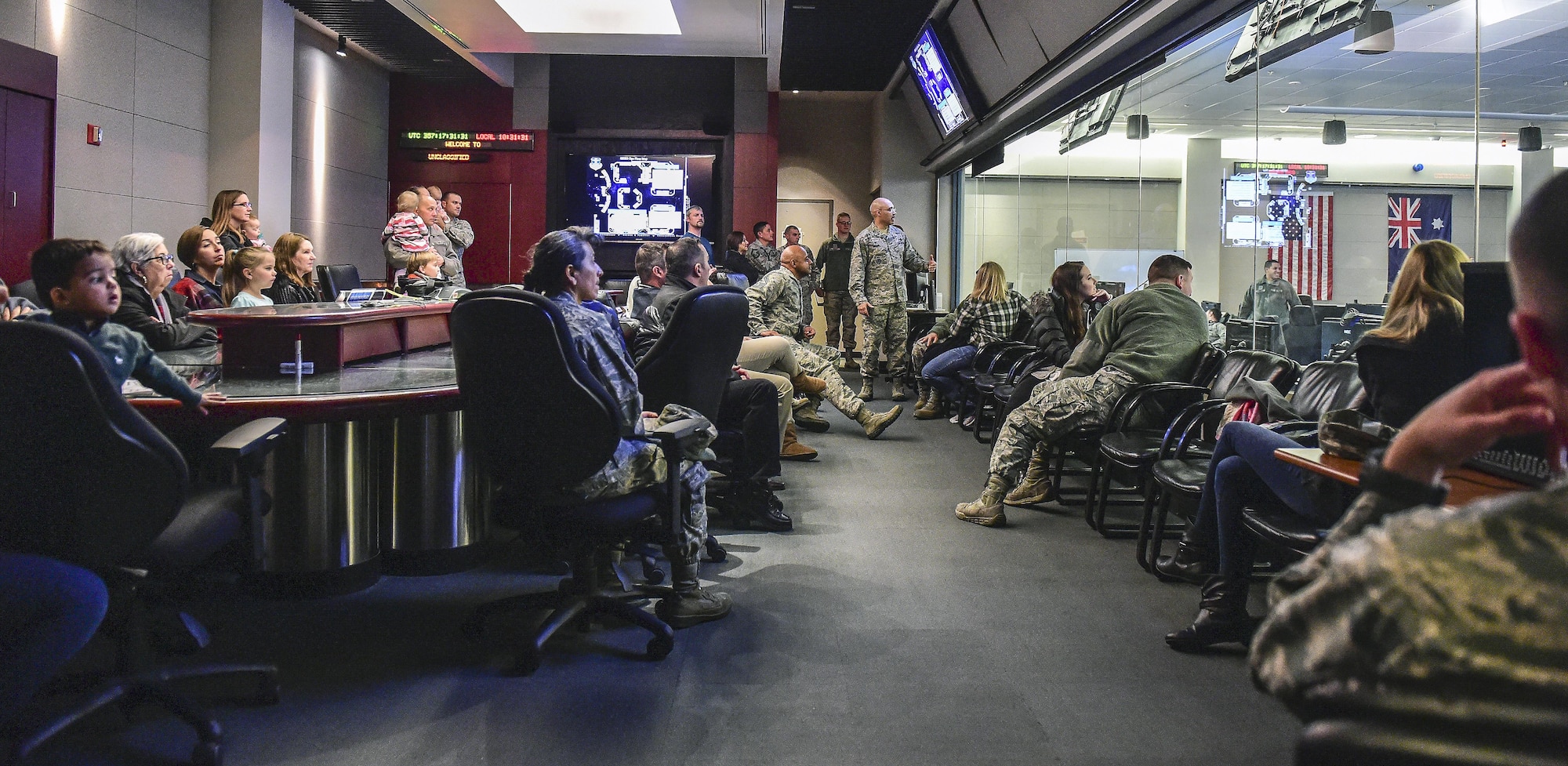 The 460th Operations Group pulls back the curtain to show attendees of Team Buckley Spouse and Family Day operators working and flying the satellites controlled inside the Mission Control Center on Buckley AFB, Colo., Dec. 22, 2016. The event consisted of families given access to see the 460th Space Wing mission up close, with demonstrations from the operators, Defenders, and firefighters. (U.S. Air Force photo by Tech. Sgt. Nicholas Rau/Released)