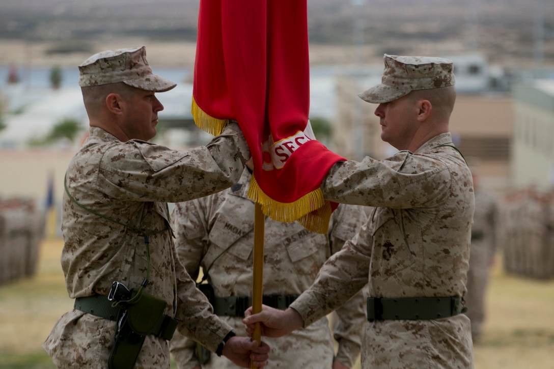 Lt. Col. Christopher T. Steele, outgoing commander and Lt. Col. Jonathan Q. Kenney, oncoming commander, 2nd Battalion, 7th Marine Regiment, exchange the battalion’s colors during the units change of command ceremony at Lance Cpl. Torrey L. Gray Field aboard Marine Corps Air Ground Combat Center Twentynine Palms, Calif., Dec. 15, 2016. 