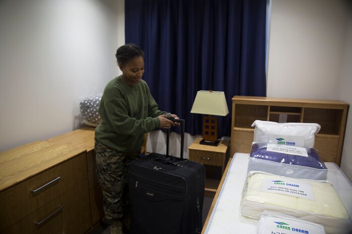 U.S. Marine Corps Lance Cpl. Lashawna Clayborn, expeditor specialist, places her luggage in her new room at Marine Corps Air Station Iwakuni, Japan, Dec. 23, 2016. Marine Aerial Refueler Transport Squadron (VMGR) 152 Marines moved barracks to make the commute to work more efficient. The Marines were provided two moving trucks and a bus to shuttle themselves and their belongings to the location of their new barracks. (U.S. Marine Corps photo by Lance Cpl. Gabriela Garcia-Herrera)