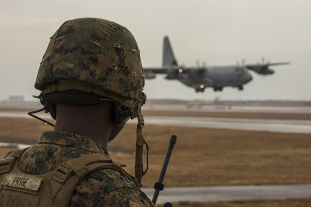 U.S. Marine Corps Staff Sgt. George Price, an Marine Air Traffic Control Mobile Team (MMT) instructor with Marine Air Control Squadron  (MACS) 4 Detachment Bravo, directs a KC-130J Hercules with Marine Aerial Refueler Transport Squadron (VMGR) 152 during a landing as part of aircraft landing zone training at Marine Corps Air Station Iwakuni, Japan, Dec. 21, 2016. The training allows the Marines to gain experience, practice constructing an expeditionary airfield, and complete training and readiness requirements. The MMT Marines conduct this training every three to six months to refine the Marines’ skills, keeping them ready for expeditionary operations while in a garrison environment. (U.S. Marine Corps photo by Cpl. Aaron Henson)
