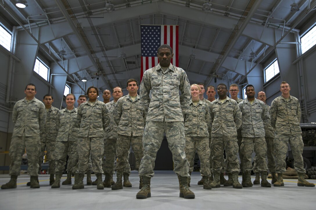U.S. Air Force Staff Sgt. Preston Moten, 20th Equipment Maintenance Squadron aerospace ground equipment schedule and training monitor, stands in front of 20th EMS Airmen at Shaw Air Force Base, S.C., Dec. 9, 2016. Moten had retained negative habits from his life prior to the Air Force that jeopardized his career and the safety of his fellow Airmen, but used the support and guidance offered by his team members to break those habits and become more resilient. (U.S. Air Force photo by Airman 1st Class Kathryn R.C. Reaves)