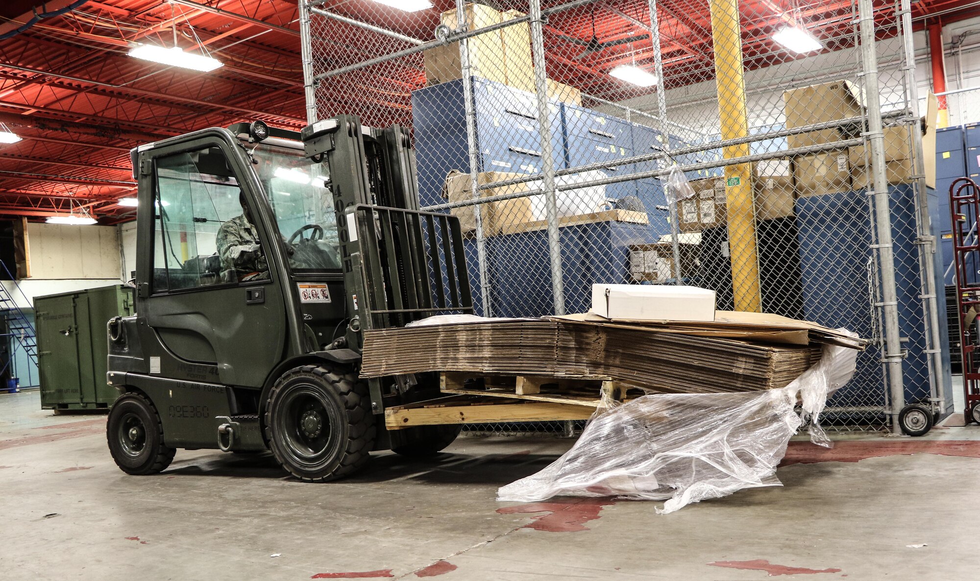 Senior Airman William Lawson, 927th Logistics Readiness Squadron material manager operates a forklift filled with boxes on Dec. 20, 2016 at MacDill Air Force Base, FL. Lawson was in during the week to assist the 927 LRS with clearing storage space. (U.S. Air Force photo by Senior Airman Xavier Lockley)