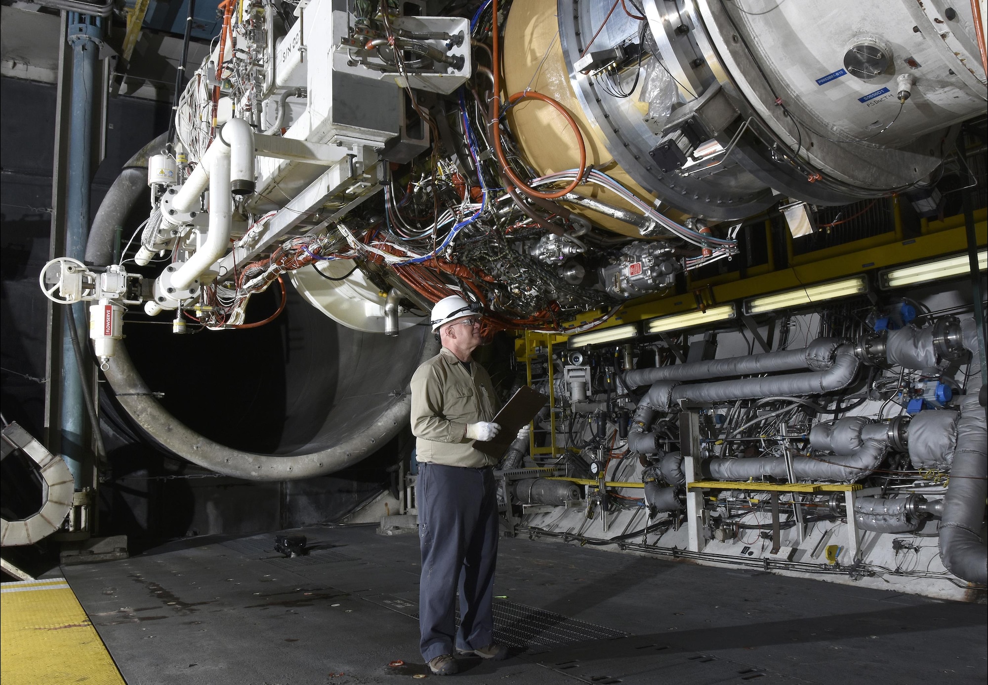 Neil Aukeman, AEDC outside machinist, prepares the General Electric Passport 20 engine, which powers the Bombardier Global 7000 and 8000 business jets, for testing in an engine test cell at AEDC. (U.S. Air Force photo/Rick Goodfriend)