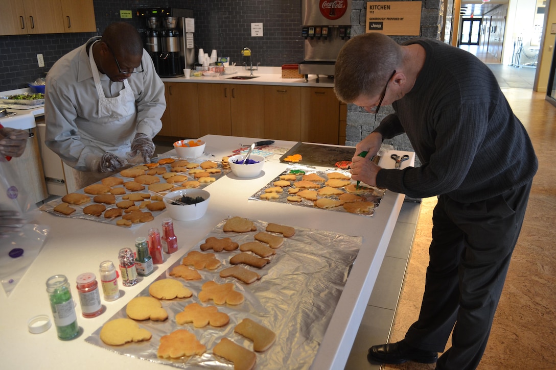 George Gray (left) and Bill Farmer decorate cookies at the USO-Metro Warrior and Family Center, Fort Belvoir, Virginia, Dec. 21, 2016.