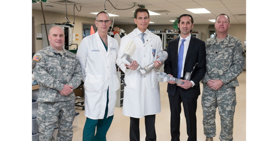 From left, Army Col. Michael Heimall, director of Walter Reed National Military Medical Center in Bethesda, Md.; Air Force Col. (Dr.) Jeffrey Bailey, Walter Reed’s director for surgery; Dr. Paul Pasquina, Walter Reed’s chief of orthopedics and rehabilitation; Dr. Justin Sanchez, director of the Defense Advanced Research Projects Agency’s Biological Technologies Office; and Lt. Col. (Dr.) Keith Myers, director of Walter Reed’s Amputee Clinic, pose for a photo at Walter Reed following a ceremony marking the delivery of a groundbreaking upper-limb prosthesis, Dec. 22, 2016. DoD photo