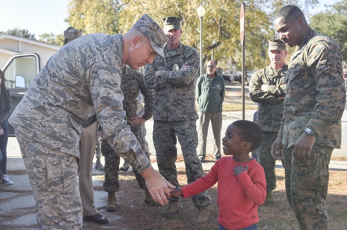 U.S. Air Force Col. Robert Lyman, Joint Base Charleston commander, left, shakes hands with Ruben Barnett Jr., right, at his new home Dec. 21, 2016. Barnett and his son lost all of their belongings in a house fire the day before Thanksgiving. 