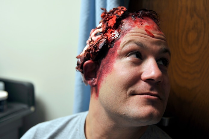Master Sgt. Darryl Lane, 628th Medical Group training manager, displays head trauma moulage makeup prior to a mass casualty exercise at Joint Base Charleston, South Carolina on Dec. 21, 2016. The exercise evaluated response capabilities of the medical personnel assigned to the 628 MDG.