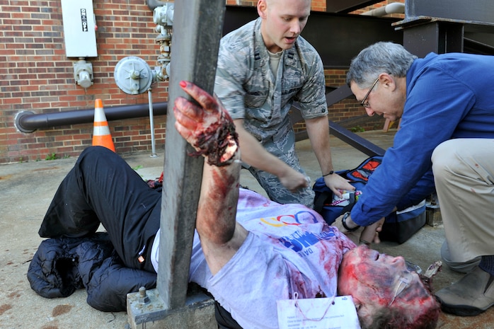 Capt. Allen Hauser, a pharmacist with the 628th Medical Support Squadron (left), and Col. (ret.) Julian Levin, a flight medicine physician with the 628th Aerospace Medicine Squadron, provide medical care to a simulated patient during a mass casualty exercise at Joint Base Charleston, South Carolina, Dec. 21, 2016. The exercise evaluated how medical personnel would respond to an incident on base needing triage, medical care and patient transportation.