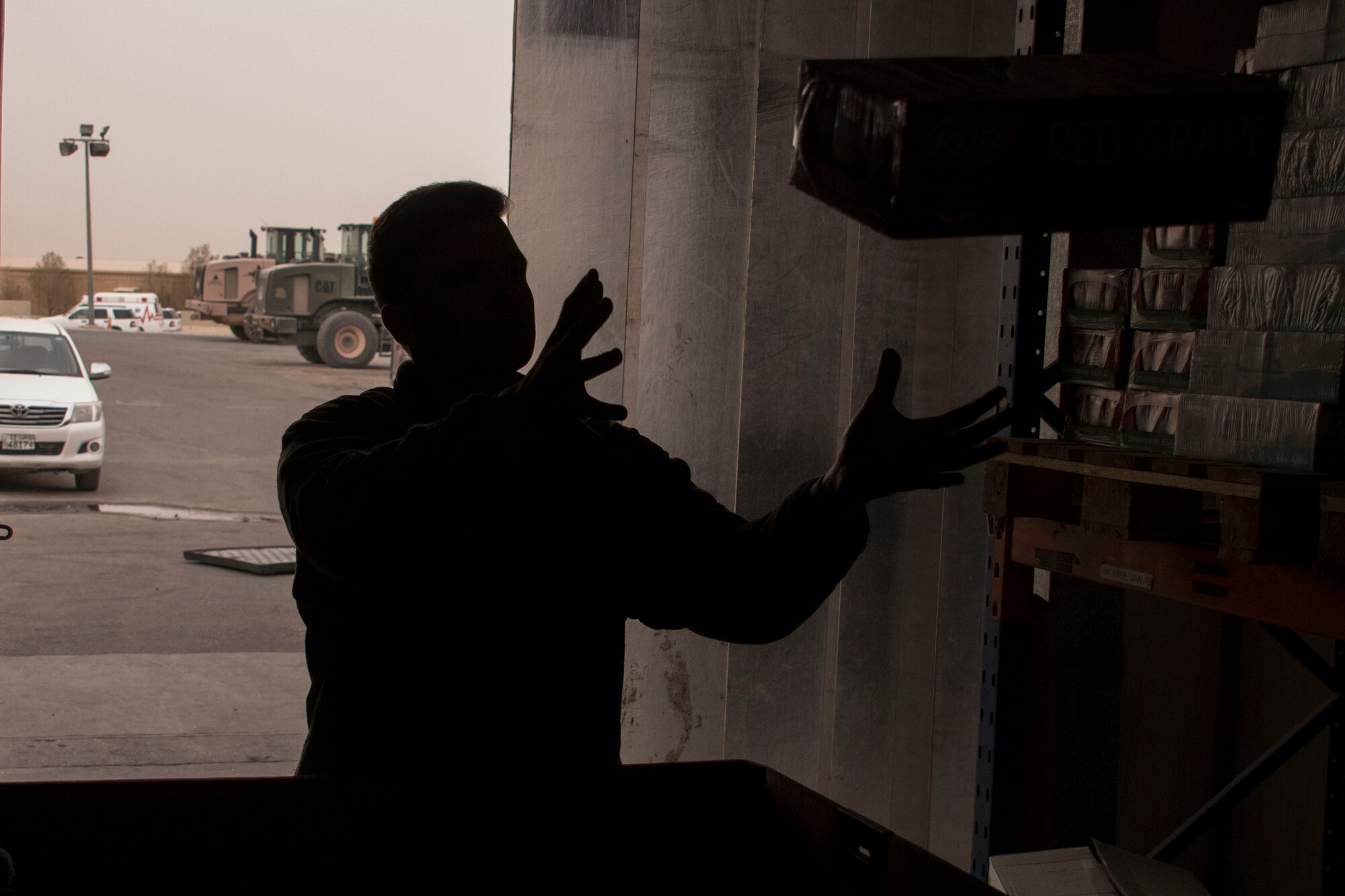 Senior Airman Gavin Payton, a 386th Expeditionary Force Support Squadron rations team member, catches a box in a storeroom Dec. 22, 2016 at an undisclosed location in Southwest Asia. The 386th EFSS Airmen worked quickly to ensure the tri-walls of holiday food items would be ready in time to ship to forward-deployed service members before Christmas. (U.S. Air Force photo/Senior Airman Andrew Park)