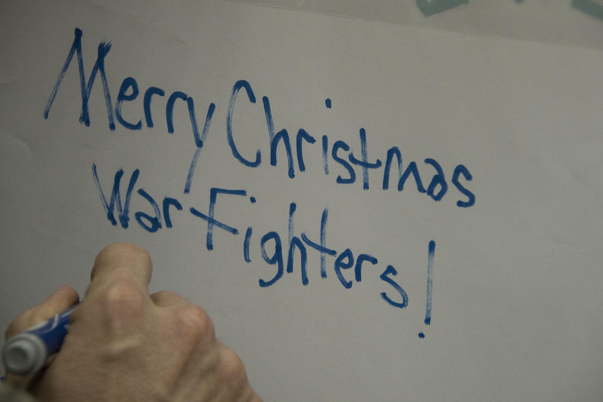 Chief Master Sgt. James Lucas, 386th Expeditionary Mission Support Group superintendent, writes a holiday greeting on the top of a box containing holiday meals for forward-deployed service members Dec. 23, 2016 at an undisclosed location in Southwest Asia. After the boxes were loaded with holiday meal items, they were loaded into the back of a C-130H Hercules and delivered to the austere locations where these service members are currently deployed. (U.S. Air Force photo/Senior Airman Andrew Park)