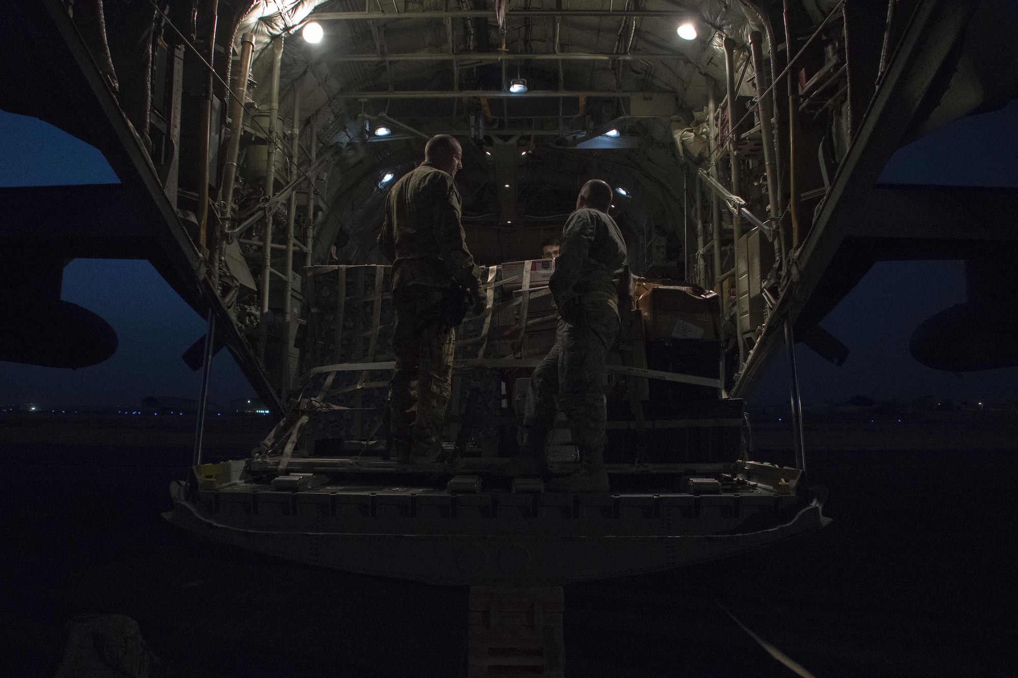 Loadmasters from the 386th Expeditionary Logistics Readiness Squadron secure pallets in the cargo area of a C-130H Hercules Dec. 23, 2016 at an undisclosed location in Southwest Asia. They loaded approximately 18,500 pounds of goods onto the Hercules. (U.S. Air Force photo/Senior Airman Andrew Park)