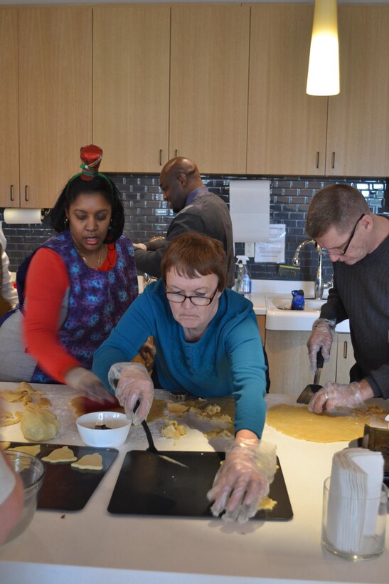 From left: Dorothy Russell, Judy Durnin and Bill Farmer shape dough into cookie shapes.