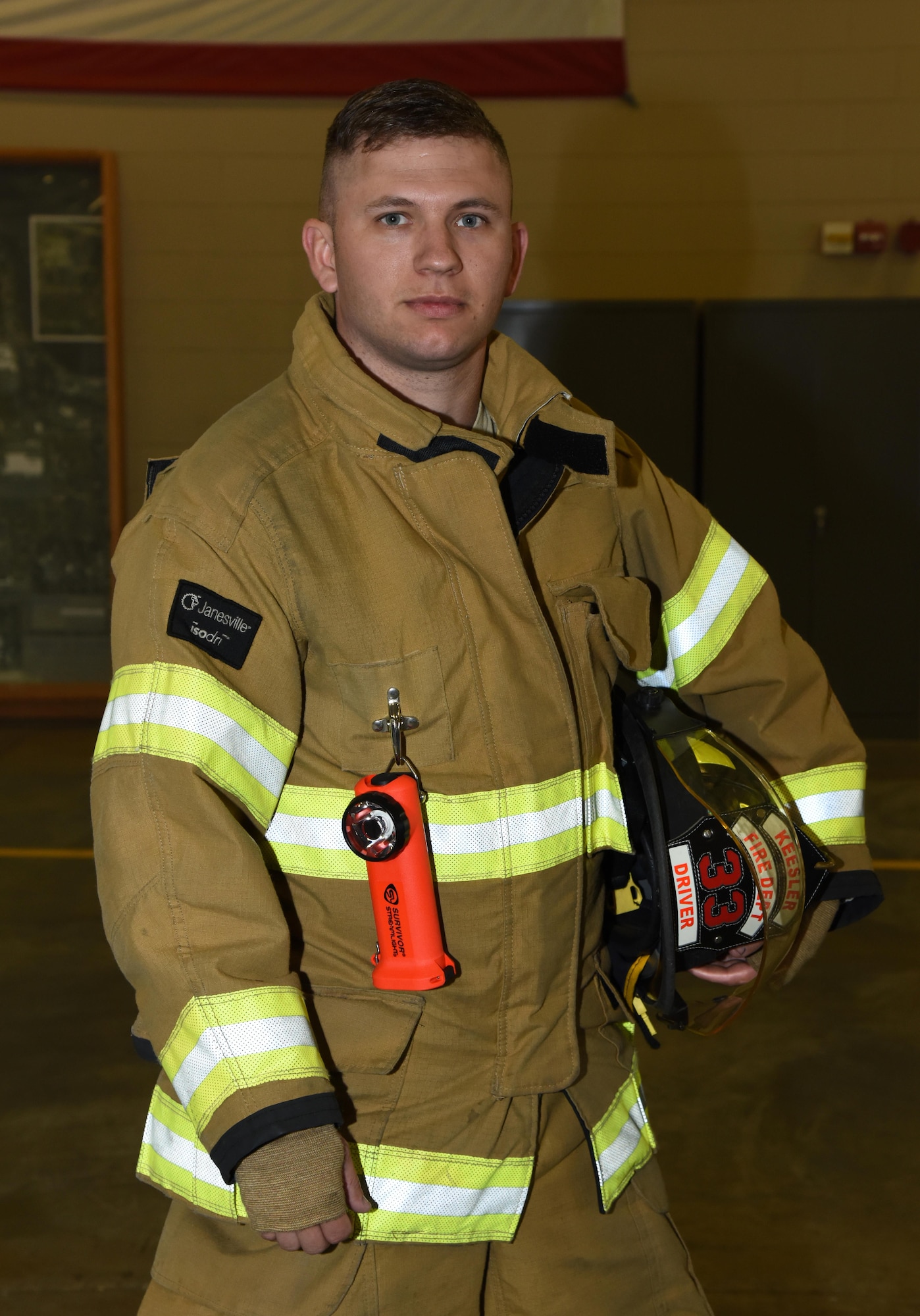 Senior Airman Tyler Fisher, 81st Infrastructure Division firefighter, poses for a photo Dec. 15, 2016, on Keesler Air Force Base, Miss. Fisher has been in the Air Force for four years and after graduating technical school, he found out his first base was the same base as his father. (U.S. Air Force photo by Kemberly Groue)