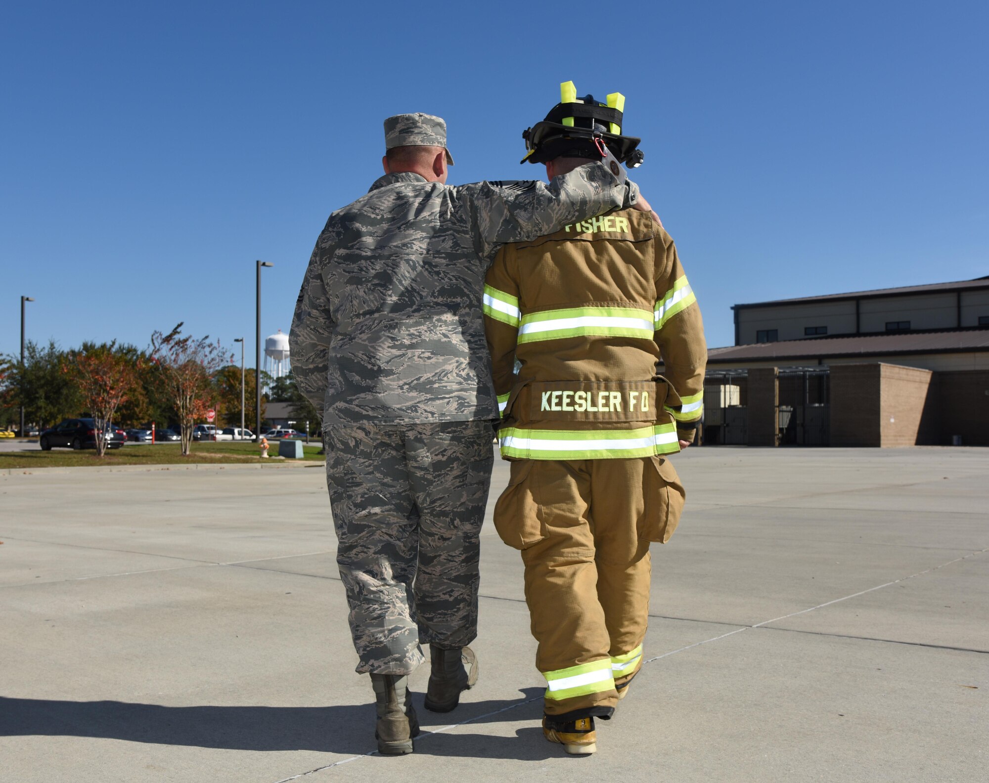 Chief Master Sgt. Anthony Fisher, 81st Training Group superintendent, walks with his son, Senior Airman Tyler Fisher, 81st Infrastructure Division firefighter, Dec. 15, 2016, on Keesler Air Force Base, Miss. After serving at Keesler 3 years ago, Chief Fisher returned after he secured a superintendent position, which placed him at his son’s first duty station. (U.S. Air Force photo by Kemberly Groue)