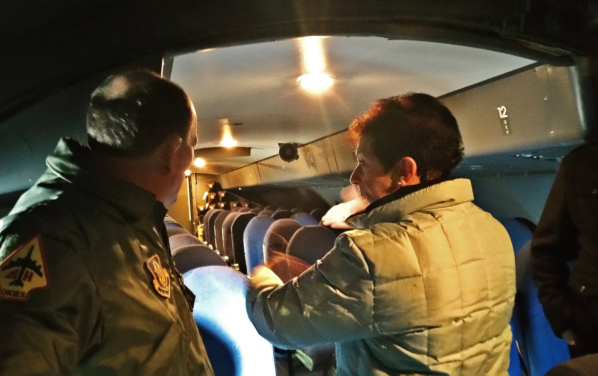 Retired Col. Regina Aune, right, describes to Col. Thomas K. Smith, 433rd Airlift Wing commander, Dec. 19, 2016, how the children were bedded down in the overhead troop compartment of the aircraft, during “Operation Babylift.” Aune was on the first military aircraft to Vietnam to bring the refugees to the United States. “Operation Babylift” was a combined effort between the United States, Canada, Australia and France, to evacuate more than 3,300 refugees from South Vietnam. (U.S. Air Force photo by Minnie Jones)     