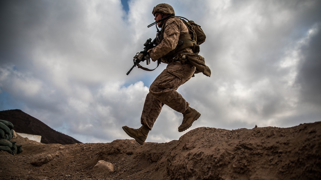 U.S. Marine Cpl. Andrew Wilson, a squad leader with Battalion Landing Team 1st Bn., 4th Marines, 11th Marine Expeditionary Unit, jumps into a bunker to find cover during a squad assault rehearsal as part of Exercise Alligator Dagger, Dec. 17. During the drills, the Marines were met with scenarios that they adapted to as a team, including assaulting the objective when they were receiving little to no simulated enemy fire, and taking cover or maintaining the suppressive fire on the enemy when they were met with effective sporadic fire. The unilateral exercise provides an opportunity for the Makin Island Amphibious Ready Group and 11th MEU to train in amphibious operations within the U.S. 5th Fleet area of operations. The 11th MEU is currently supporting U.S. 5th Fleet’s mission to promote and maintain stability and security in the region.