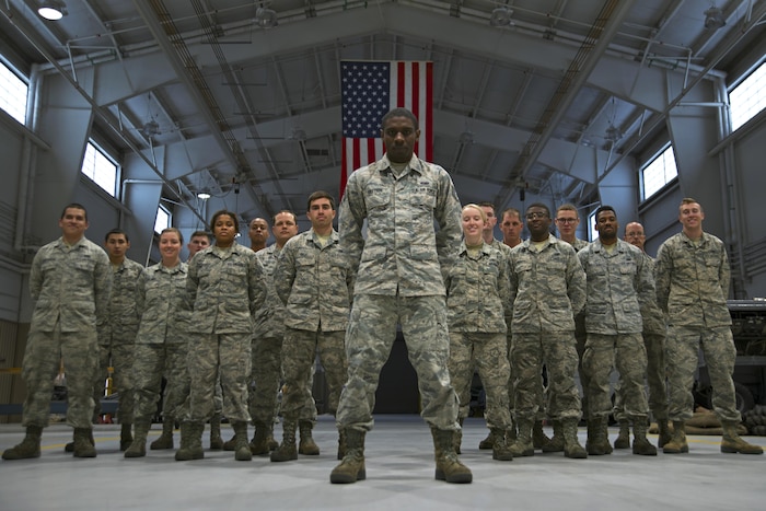 U.S. Air Force Staff Sgt. Preston Moten, 20th Equipment Maintenance Squadron aerospace ground equipment schedule and training monitor, stands in front of 20th EMS Airmen at Shaw Air Force Base, S.C., Dec. 9, 2016. Moten had retained negative habits from his life prior to the Air Force that jeopardized his career and the safety of his fellow Airmen, but used the support and guidance offered by his team members to break those habits and become more resilient. (U.S. Air Force photo by Airman 1st Class Kathryn R.C. Reaves)