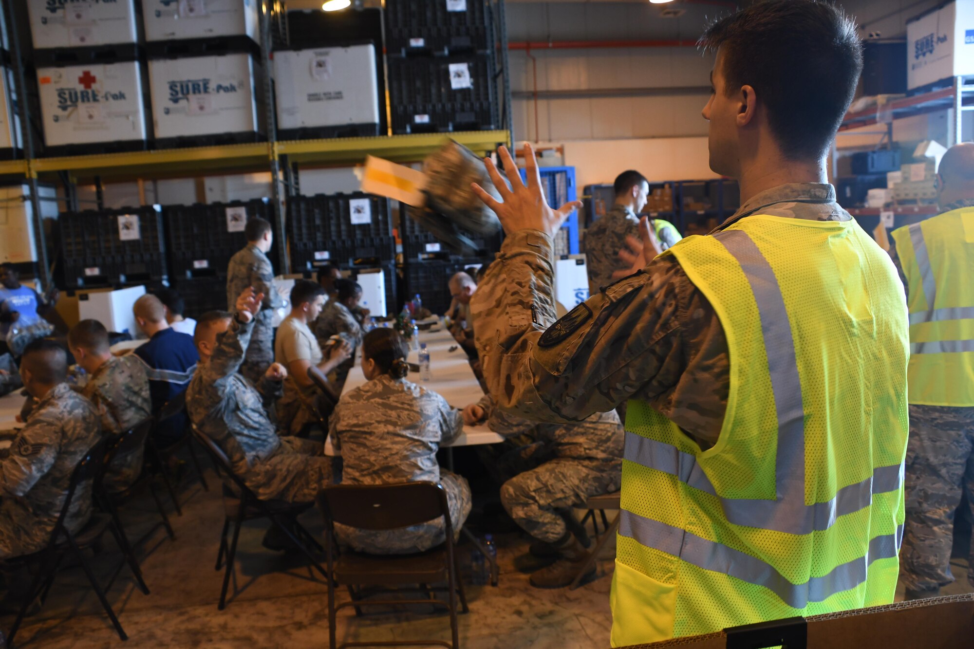 U.S. Air Force Senior Airman Terrell Richards, a medical logistics technician with the 379th Expeditionary Medical Support Squadron, catches a joint first aid kit at Al Udeid Air Base, Qatar, Dec. 20, 2016. JFAK’s are distributed to Airmen going into potential areas of conflict and are used to help save lives in combat situations. (U.S. Air Force photo by Senior Airman Miles Wilson)