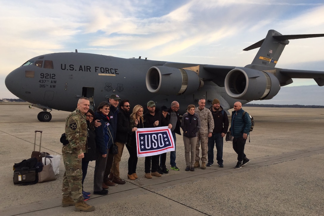 Marine Corps Gen. Joe Dunford, chairman of the Joint Chiefs of Staff, stands for a photo with members of the USO troupe he's traveling with to visit troops over the holidays. The group arrived in Baghdad on Christmas Eve. 