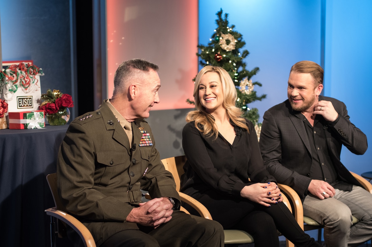 Marine Corps Gen. Joe Dunford, chairman of the Joint Chiefs of Staff, country music artist Kellie Pickler, and Pickler’s husband, country music songwriter Kyle Jacobs, speak between television and radio interviews at the National Press Club in Washington about their USO Tour to the Middle East to visit troops for the holidays, Dec. 23, 2016. DoD photo by Army Sgt. James K. McCann