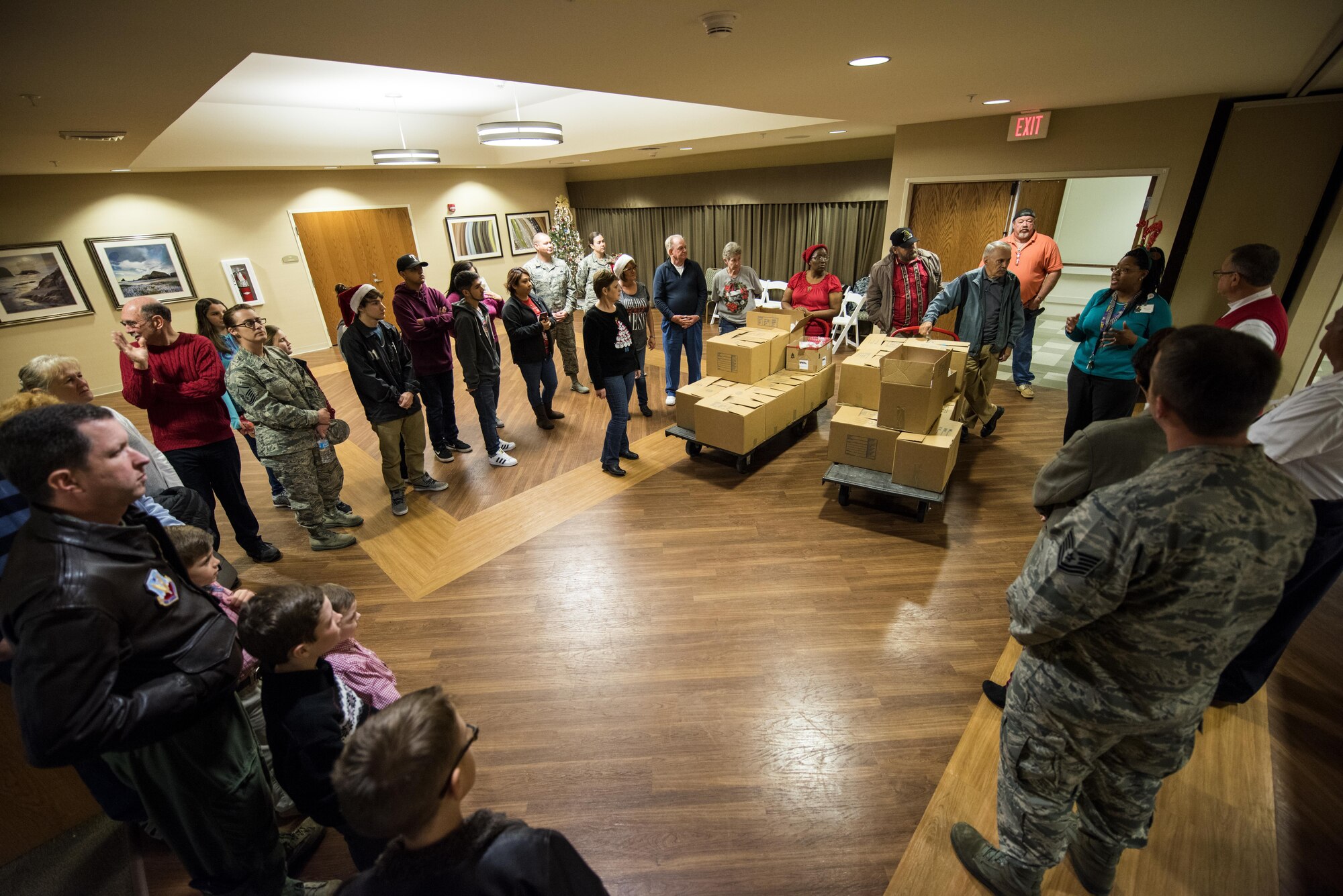 Members of Seymour Johnson Air Force Base, North Carolina, the Goldsboro Elks Lodge #139, and the local Wayne County community receive instructions before visiting with the residents of the N.C. Veterans Home, Dec. 24, 2016, in Kinston, North Carolina. More than 45 people volunteered to pass out goody bags and holiday cards to the veterans. (U.S. Air Force photo by Airman Shawna L. Keyes)