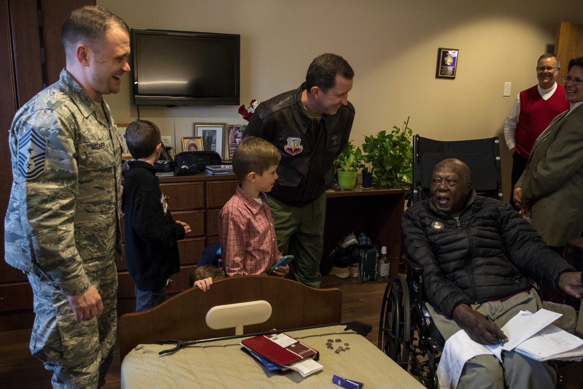 Chief Master Sgt. Shane Wagner (left), 4th Fighter Wing command chief, and Col. Christopher Sage (center), 4th FW commander, laugh with Eugene Shaw, U.S. Army veteran and resident of the North Carolina State Veterans Home, Dec. 24, 2016, in Kinston, North Carolina. Sage and Wagner and more than 45 volunteers visited with over 90 veterans and passed out goody bags and holidays cards. (U.S. Air Force photo by Airman Shawna L. Keyes)