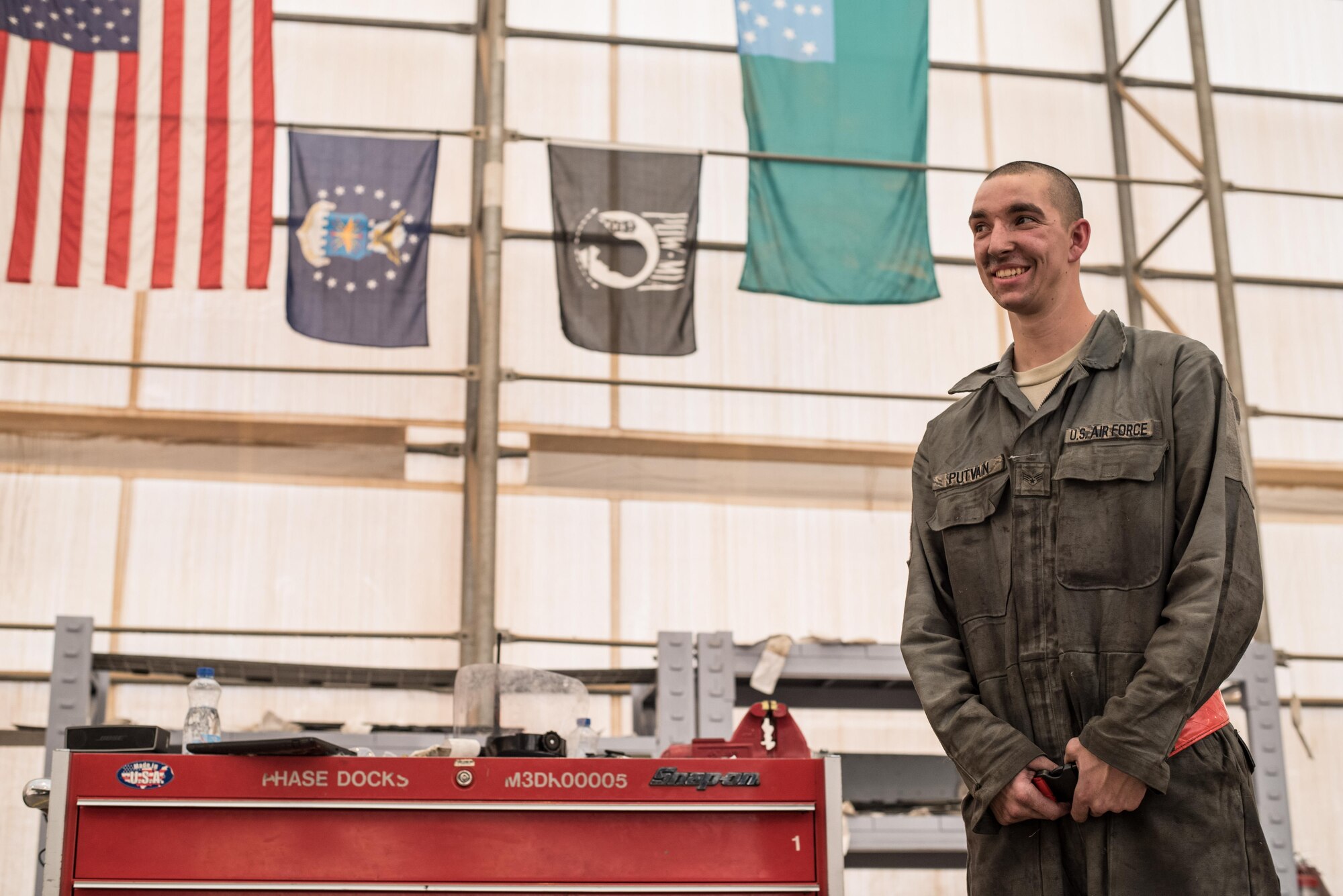 Senior Airman Sid Putvain, 407th Expeditionary Maintenance Squadron, talks with his leadership at an undisclosed location in Southwest Asia, Dec. 25, 2016. Putvain is one of many deployed Airmen who must maintain F-16 Fighting Falcons on Christmas day to ensure they are ready to fly missions in support of Operation Inherent Resolve. (U.S. Air Force photo/Master Sgt. Benjamin Wilson)