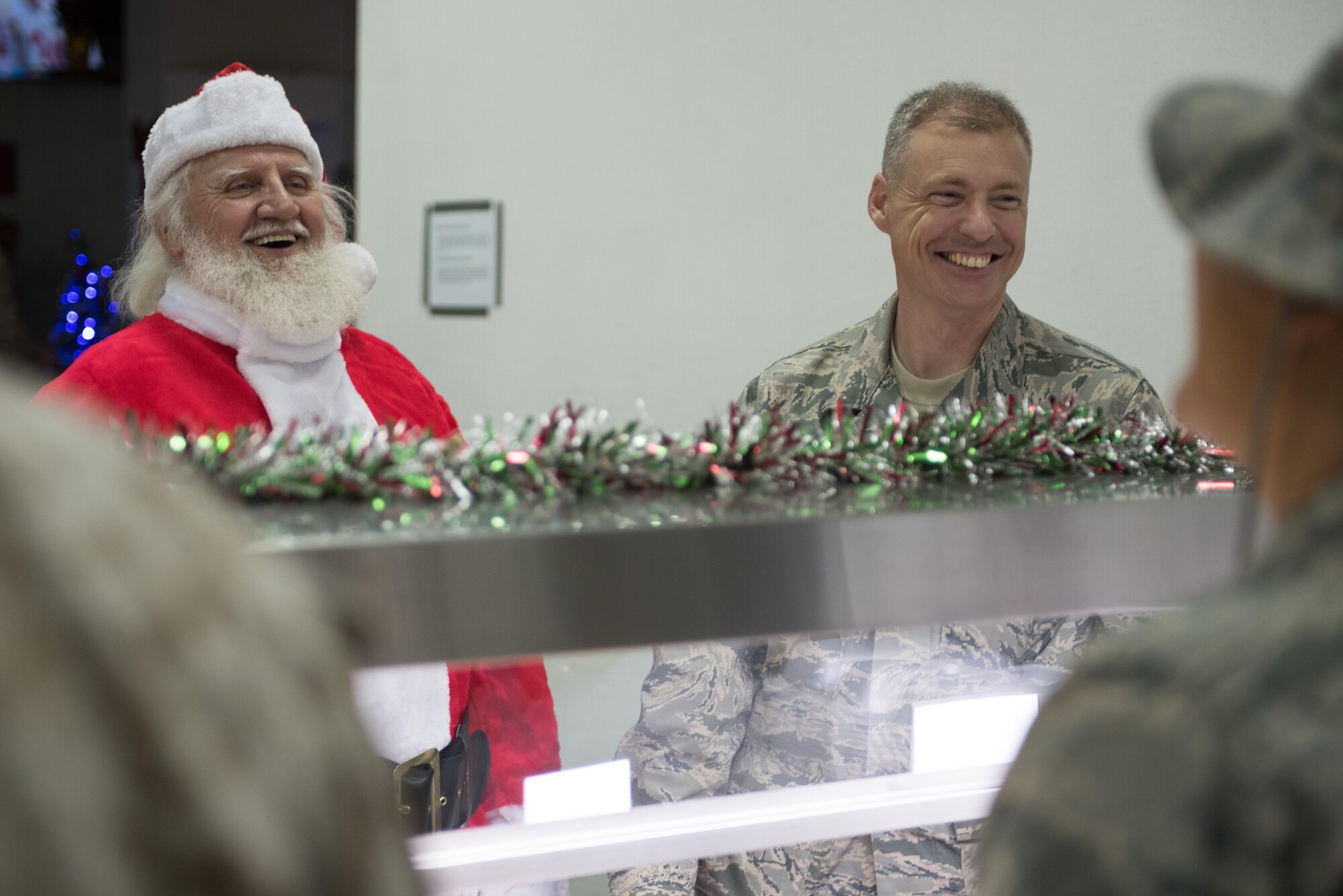Santa Claus laughs with Senior Master Sgt. Thomas Mattern, 407th Expeditionary Logistics Readiness Squadron, at an undisclosed location in Southwest Asia, Dec. 25, 2016. The service members deployed here are supporting Operation Inherent Resolve. (U.S. Air Force photo/Master Sgt. Benjamin Wilson)