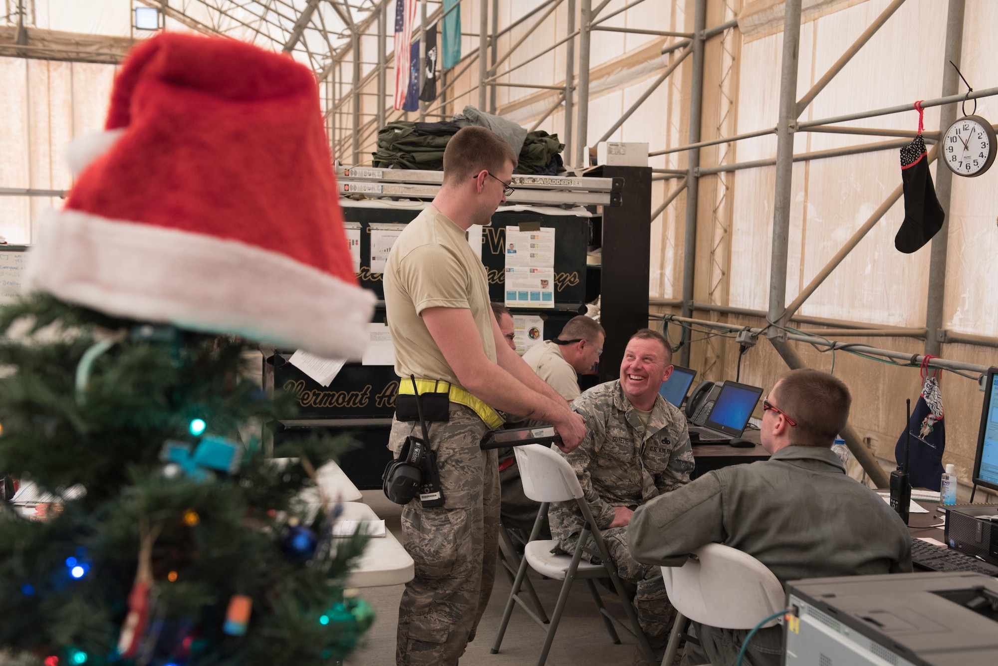 Senior Master Sgt. Jason Guyette, 407th Expeditionary Maintenance Squadron inspection element supervisor, laughs as he discusses the days work with his Airmen at the 407th Air Expeditionary Group, Dec. 25, 2016. The Airmen must maintain F-16 Fighting Falcons on Christmas day to ensure they are ready to fly missions in support of Operation Inherent Resolve. (U.S. Air Force photo/Master Sgt. Benjamin Wilson)(Released)