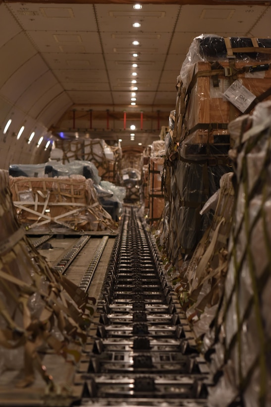 Cargo waits as Airmen with the 8th Expeditionary Air Mobility Squadron prepare to offload it at Al Udeid Air Base, Qatar, Dec. 24, 2016. The 8th EAMS Airmen work round the clock to ensure cargo is loaded and offloaded in an expedient manner.  (U.S. Air Force photo by Senior Airman Cynthia A. Innocenti)