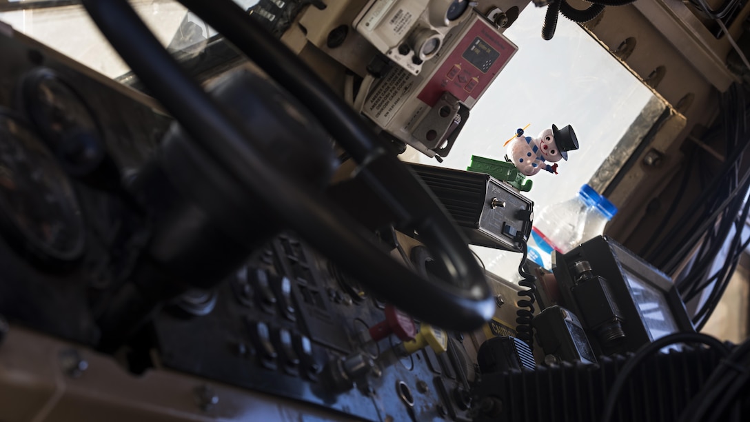 A snowman figurine sits on the dashboard of a mine-resistant, ambush-protected, all-terrain vehicle belonging to the 455th Expeditionary Security Forces Squadron before a team left for patrols Dec. 25, 2016 at Bagram Airfield, Afghanistan. Units put up holiday decorations sent from home throughout their areas to help celebrate the season. (U.S. Air Force photo by Staff Sgt. Katherine Spessa)