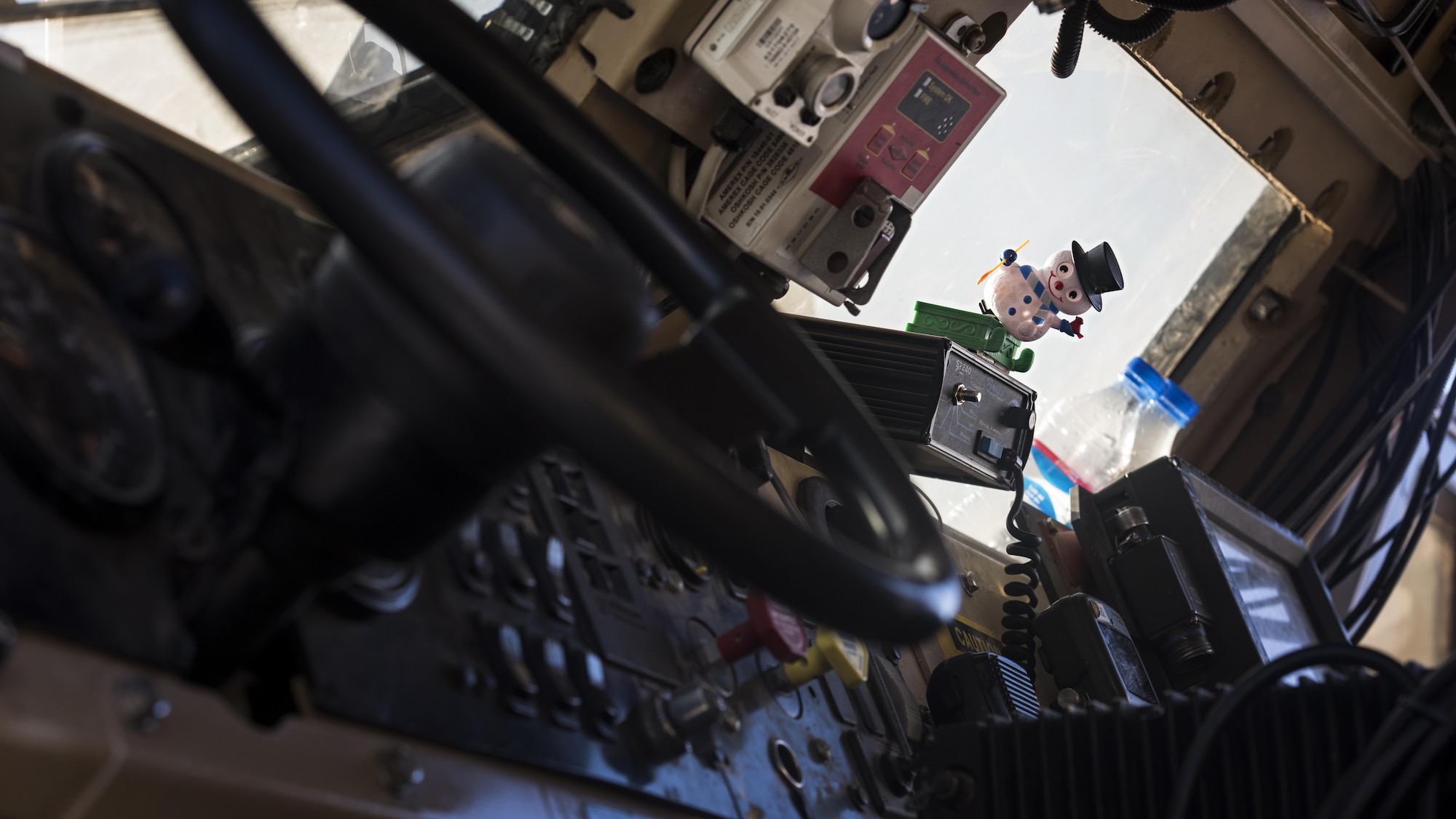 A snowman figurine sits on the dashboard of a mine-resistant, ambush-protected, all-terrain vehicle belonging to the 455th Expeditionary Security Forces Squadron before a team left for patrols Dec. 25, 2016 at Bagram Airfield, Afghanistan. Units put up holiday decorations sent from home throughout their areas to help celebrate the season. (U.S. Air Force photo by Staff Sgt. Katherine Spessa)