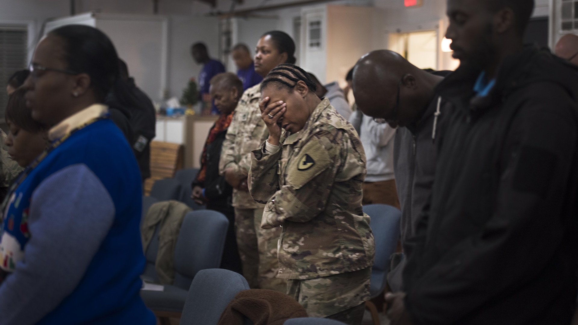 Sgt. Maj. Velma Lyons, Army Field Support Battalion-Afghanistan battalion sergeant major, prays during a Christmas gospel service Dec. 25, 2016 at the Enduring Faith Chapel, Bagram Airfield, Afghanistan. While holidays away from families can be challenging, service members celebrated Christmas by attending church and spending time with friends. (U.S. Air Force photo by Staff Sgt. Katherine Spessa)