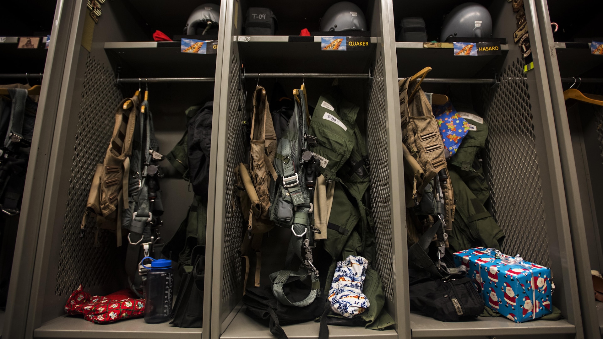 Christmas presents sit in lockers alongside flight gear in the 79th Expeditionary Fighter Squadron Dec. 25, 2016 at Bagram Airfield, Afghanistan. Many units held Secret Santa or White Elephant gift exchanges, along with other holiday events to celebrate Christmas while deployed. (U.S. Air Force photo by Staff Sgt. Katherine Spessa)