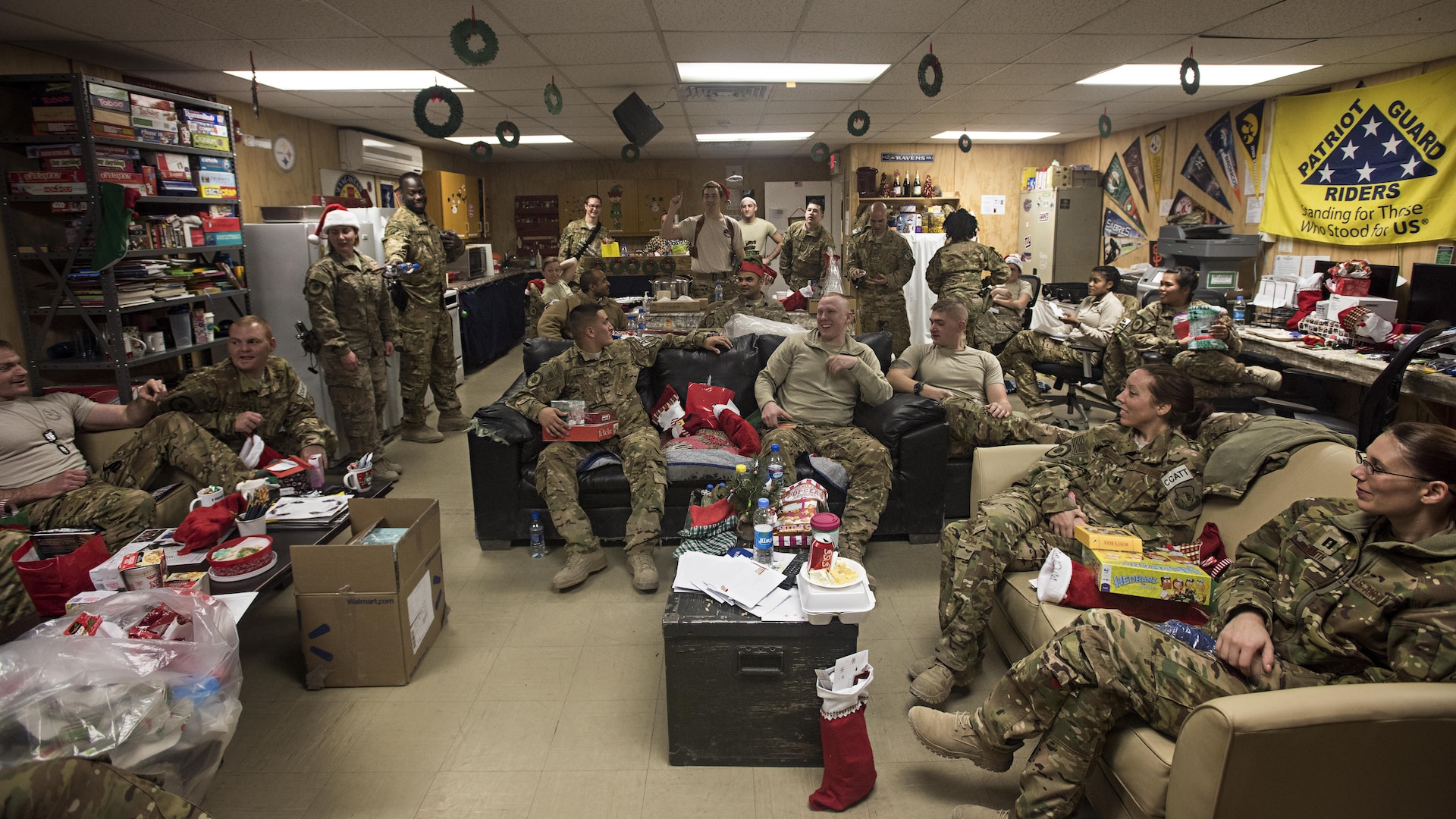 Members of the 455th Expeditionary Aeromedical Evacuation Squadron participate in a white elephant gift exchange Dec. 25, 2016 at Bagram Airfield, Afghanistan. The mission continued over the holiday, but service members took time to celebrate the holiday by talking with their families and spending time with their units. (U.S. Air Force photo by Staff Sgt. Katherine Spessa)