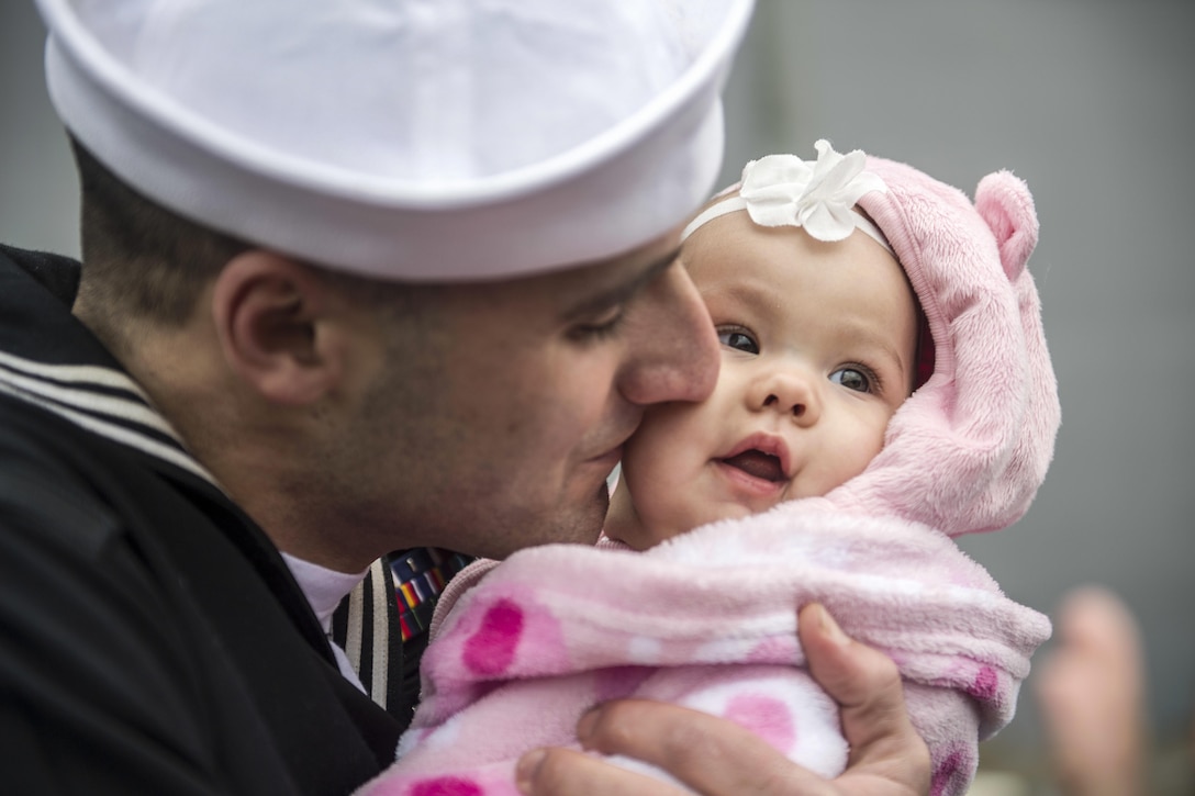 A sailor greets his daughter after returning home to Norfolk, Va., Dec. 24, 2016, after a six-month deployment aboard the amphibious assault ship USS Wasp to support maritime security operations and theater security cooperation efforts in Europe and Middle East. Navy photo by Petty Officer 2nd Class Andrew Schneider