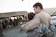 Capt. Christopher and 2nd Lt. Leigh Ann embrace each other at an undisclosed location in Southwest Asia, Dec. 22, 2016. The married couple was reunited a day before their wedding anniversary and two days before Christmas when Christopher surprised Leigh Ann during her work shift at the 380th Air Expeditionary Wing. (U.S. Air Force photo | Senior Airman Tyler Woodward)