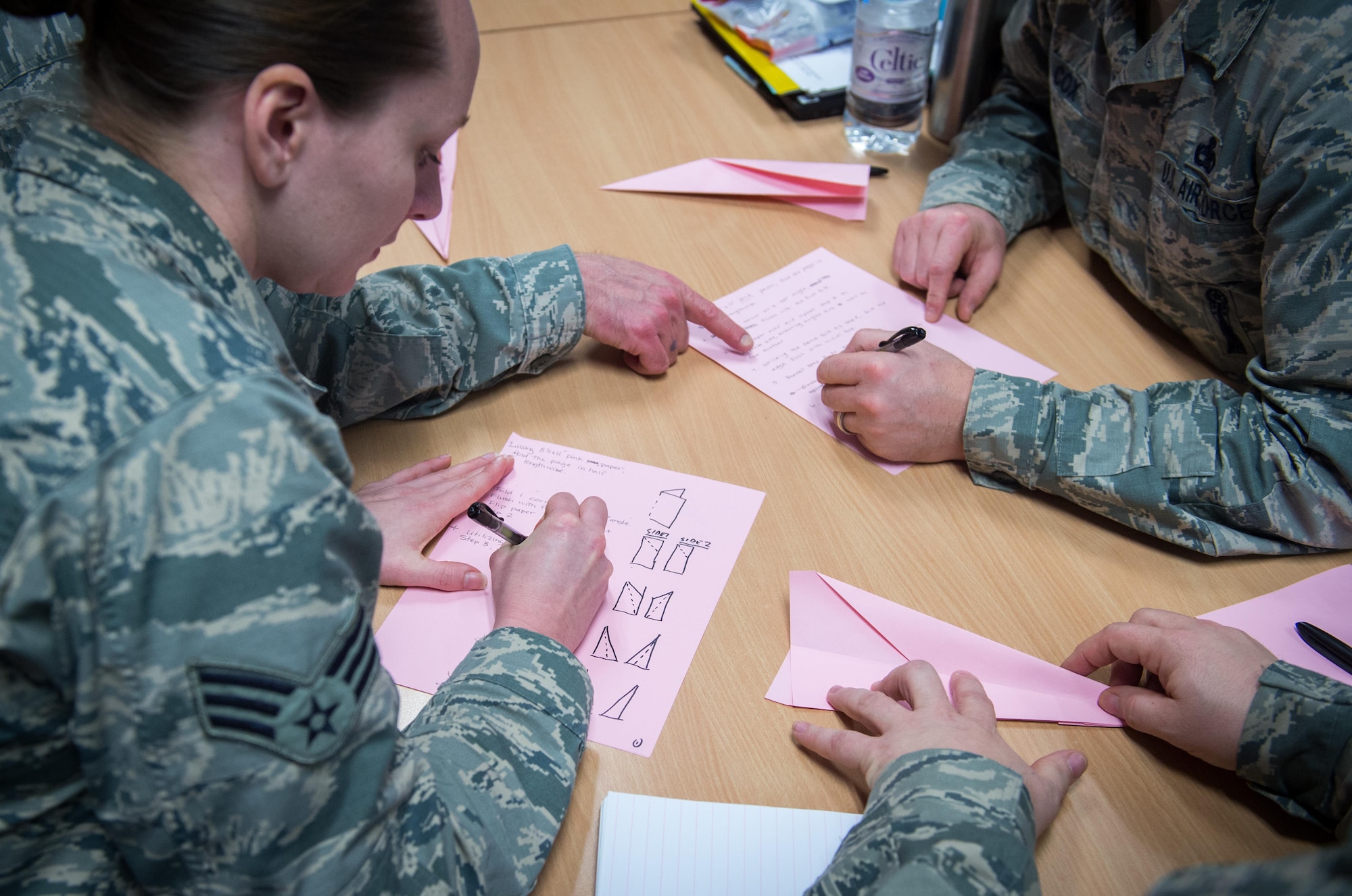Airmen develop a detailed instruction manual for building a paper airplane during a Green Belt training course at Ramstein Air Base, Germany, Dec. 15, 2016. Green Belt is a continuous process improvement initiative created in the commercial sector and harnessed by the Air Force to find better ways to accomplish the mission. This course was a streamlined version of the Green Belt course and is the first in the Air Force. (U.S. Air Force photo by Tech. Sgt. Ryan Crane)