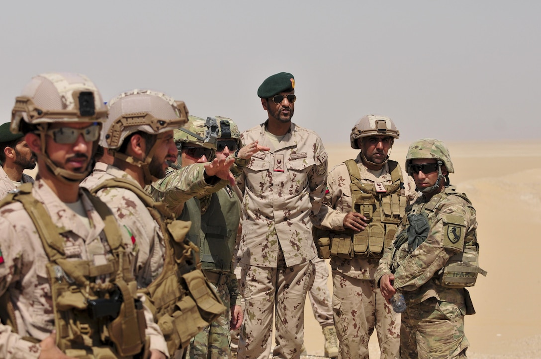 Maj. George Morris, 2nd Squadron 13th Cavalry Regiment operations and training officer, explains operations to Maj. Gen. Saleh M. Al Ameri, the commander of the UAE land forces, during an exercise at Udairi range, Kuwait, Sept. 28. U.S. and United Arab Emirate forces trained together during a multi-day exercise designed to test armored vehicle maneuver and reaction capabilities. (U.S. Army Photos by Sgt. Aaron Ellerman)