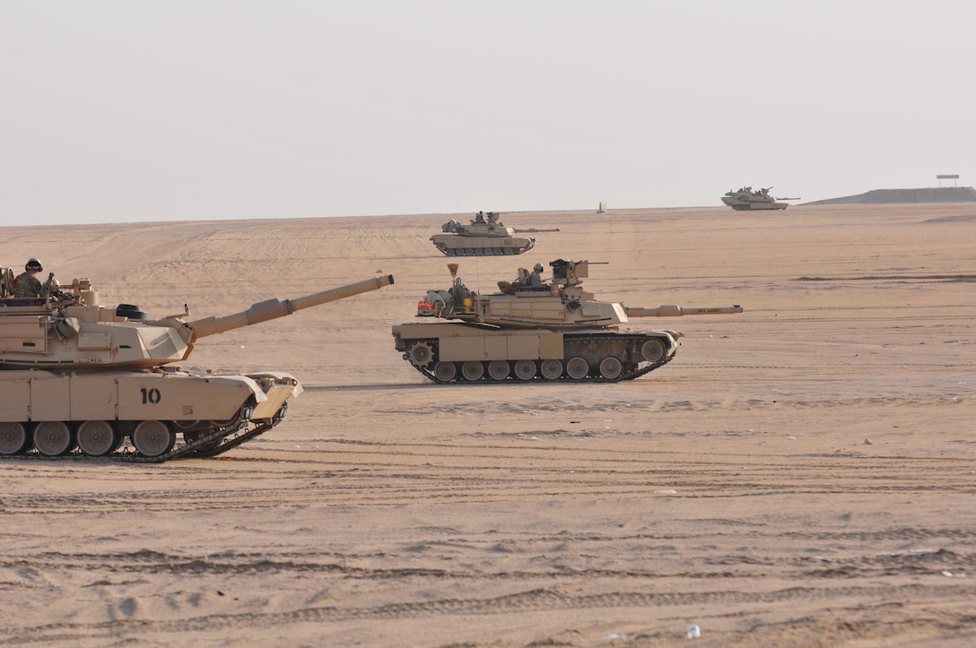 M1A2 Abrams Main Battle Tanks move to engage targets during a joint combined arms live-fire exercise near Camp Buehring, Kuwait Dec. 6-7, 2016. The multi-day exercise was designed to test the efficiency of the U.S. Army and Kuwaiti Land and Air forces abilities to identify and eliminate enemies’ anti-aircraft capabilities. Around 30 M1 Abrams Main Battle Tanks, two Kuwaiti AH-64 Apache helicopters, several Bradley Armored Fighting Vehicles, scout sniper teams, 120mm mortar teams, and M109 Self Propelled Howitzer artillery fire assaulted mock enemy positions during the exercise. (U.S. Army photo by Sgt. Aaron Ellerman)