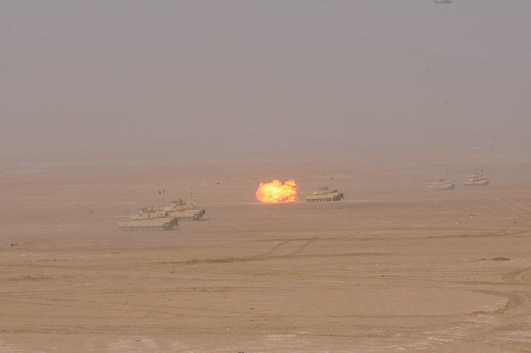 M1A2 Abrams Main Battle Tanks move to engage targets during a joint combined arms live-fire exercise near Camp Buehring, Kuwait Dec. 6-7, 2016. The multi-day exercise was designed to test the efficiency of the U.S. Army and Kuwaiti Land and Air forces abilities to identify and eliminate enemies’ anti-aircraft capabilities. Around 30 M1 Abrams Main Battle Tanks, two Kuwaiti AH-64 Apache helicopters, several Bradley Armored Fighting Vehicles, scout sniper teams, 120mm mortar teams, and M109 Self Propelled Howitzer artillery fire assaulted mock enemy positions during the exercise. (U.S. Army photo by Sgt. Aaron Ellerman)