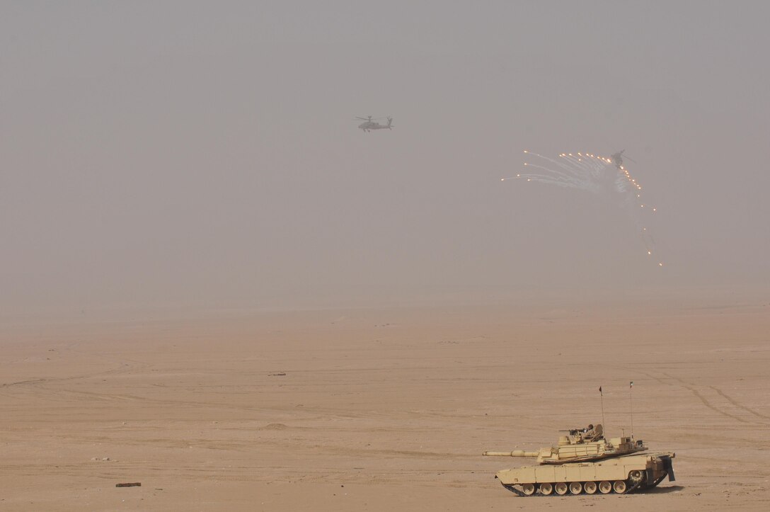 U.S. Army and Kuwaiti Land and Air forces move to engage targets during a joint combined arms live-fire exercise near Camp Buehring, Kuwait Dec. 6-7, 2016. The multi-day exercise was designed to test the efficiency of the forces abilities to identify and eliminate enemies’ anti-aircraft capabilities. Around 30 M1 Abrams Main Battle Tanks, two Kuwaiti AH-64 Apache helicopters, Several Bradley Armored Fighting Vehicles, scout sniper teams, 120mm mortar teams, and M109 Self Propelled Howitzer artillery fire, assaulted mock enemy positions during the exercise. (U.S. Army photo by Sgt. Aaron Ellerman)