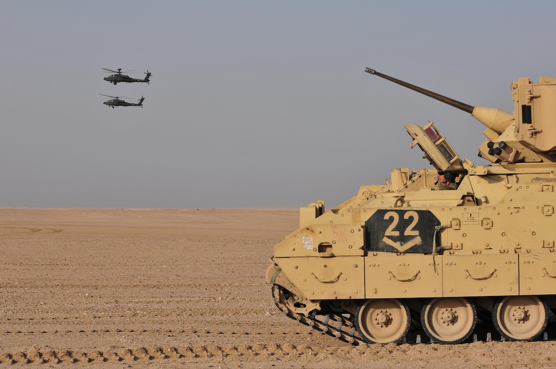 U.S. Army and Kuwaiti Land and Air forces move to engage targets during a joint combined arms live-fire exercise near Camp Buehring, Kuwait Dec. 6-7, 2016. The multi-day exercise was designed to test the efficiency of the forces abilities to identify and eliminate enemies’ anti-aircraft capabilities. Around 30 M1 Abrams Main Battle Tanks, two Kuwaiti AH-64 Apache helicopters, Several Bradley Armored Fighting Vehicles, scout sniper teams, 120mm mortar teams, and M109 Self Propelled Howitzer artillery fire, assaulted mock enemy positions during the exercise. (U.S. Army photo by Sgt. Aaron Ellerman)