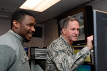 Gen. David L. Goldfein, Chief of Staff of the Air Force, watches a data presentation by Senior Airman James Taylor, 50th Security Forces Squadron, during his visit at Schriever Air Force Base, Colorado, Tuesday, Dec. 20, 2016. As CSAF, Goldfein leads more than 300,000 active duty Air Force personnel. (U.S. Air Force photo/Christopher DeWitt)