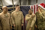 A 380th Air Expeditionary Wing KC-10 Extender aircrew laughs before a group photo after flying a sortie in support of Combined Joint Task Force-Operation Inherent Resolve at an undisclosed location in Southwest Asia, Dec. 25, 2016. KC-10 aircrews have completed more than 1,500 sorties during the liberation of Mosul, Iraq since Oct. 2016. (U.S. Air Force photo/Senior Airman Tyler Woodward)