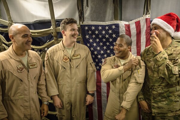 A 380th Air Expeditionary Wing KC-10 Extender aircrew laughs before a group photo after flying a sortie in support of Combined Joint Task Force-Operation Inherent Resolve at an undisclosed location in Southwest Asia, Dec. 25, 2016. KC-10 aircrews have completed more than 1,500 sorties during the liberation of Mosul, Iraq since Oct. 2016. (U.S. Air Force photo/Senior Airman Tyler Woodward)
