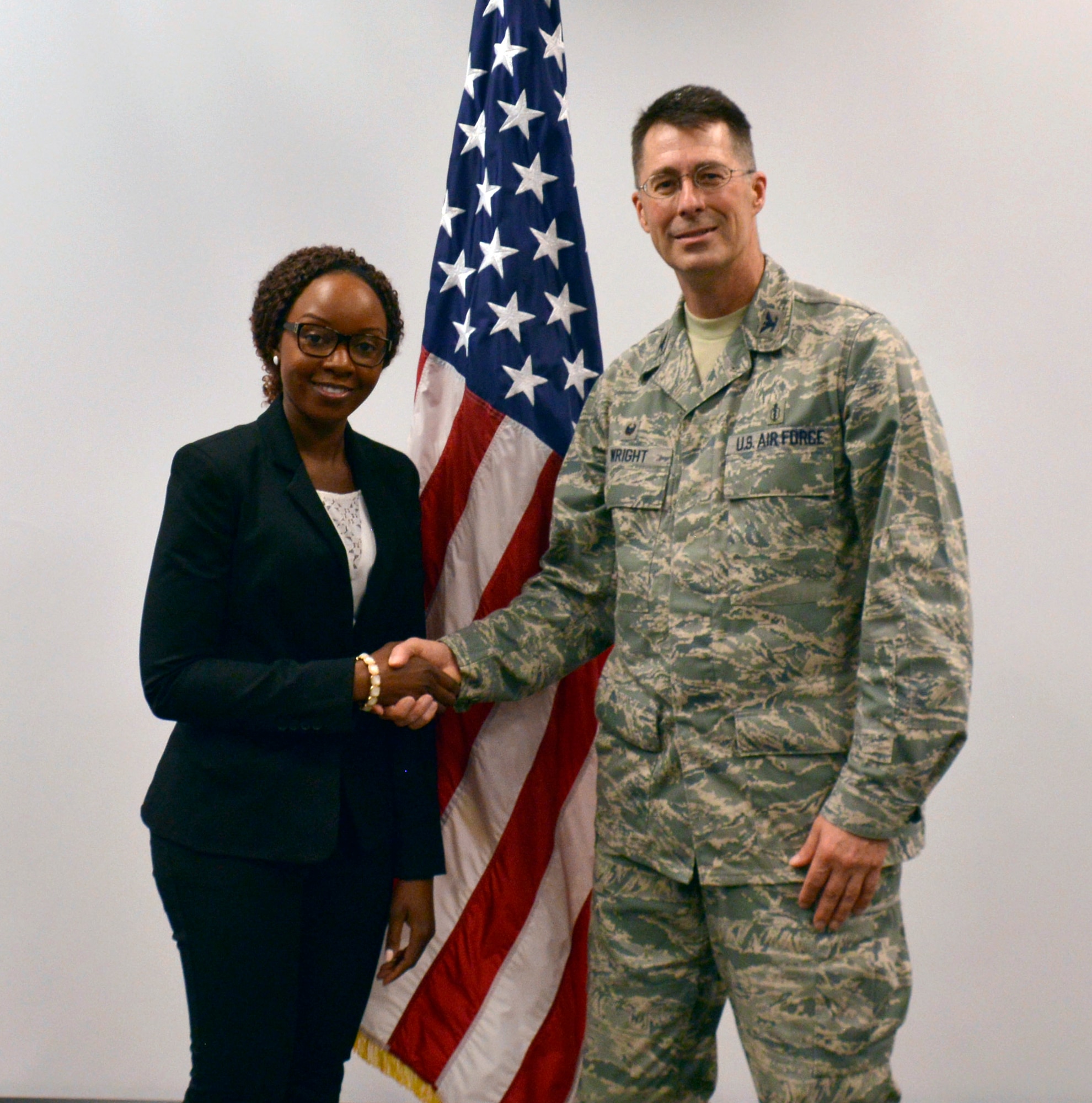 Col. (Dr.) Kenneth Wright, right, the 482nd Medical Squadron commander, Capt. (Dr.) Rachael Nambusi, left, a new physician at the 482nd MDS, pose for a photo after Nambusi signed her application for the Air Force Reserve assignment at Homestead Air Reserve Base, Fla., Dec. 10, 2016. Nambusi is the first female physician at the 482nd MDS in over a decade. (U.S. Air Force photo by Senior Airman Aja Heiden)
